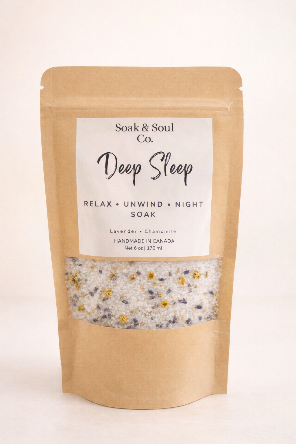 Soak & Soul Co. Deep Sleep bath soak pouch filled with white mineral salts, dried lavender buds, and chamomile flowers for nighttime relaxation.